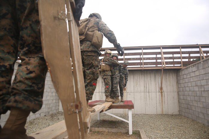 U.S. Marines with Landing Support Company, 3rd Transportation Support Battalion, Combat Logistics Regiment 3, cross an obstacle with help from Republic of Korea Marines with Landing Support Battalion, ROK Marine Logistics Group, Oct. 28, 2017 at ROK MLG Base, Pohang, South Korea. The Marines from both nations came together to conduct a Leadership Reaction Course, a series of team-building exercises designed to encourage communication and camaraderie between the two forces. The LRC was held as a part of Exercise Winter Workhorse 17/ Korean Marine Exchange Program 18.1, which builds individual Marines and Sailors’ relationships with their ROK counterparts and is the strength of III MEF in the Pacific. (U.S. Marine Corps photo by Sgt. Tiffany Edwards)