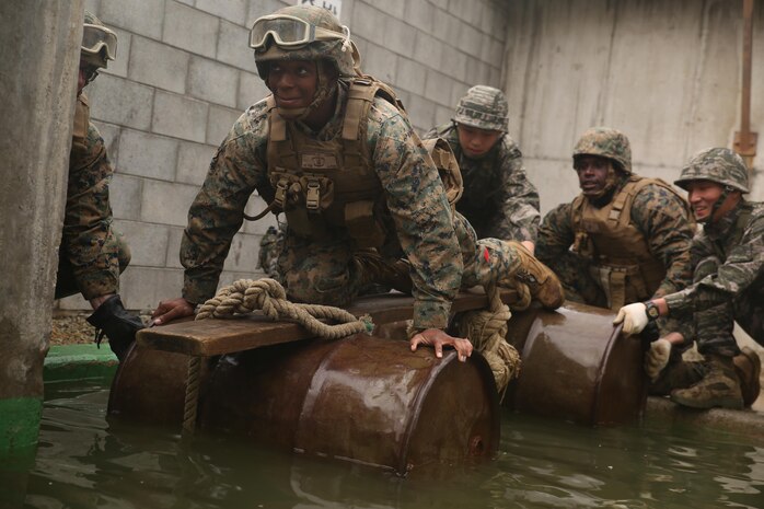 Lance Cpl. Larry Anderson, a landing support specialist with Landing Support Company, 3rd Transportation Support Battalion, Combat Logistics Regiment 3, crosses an obstacle with help from his unit and Republic of Korea Marines with Landing Support Battalion, ROK Marine Logistics Group, Oct. 28, 2017 at ROK MLG Base, Pohang, South Korea. The Marines from both nations came together to conduct a Leadership Reaction Course, a series of team-building exercises designed to encourage communication and camaraderie between the two forces. The LRC was held as a part of Exercise Winter Workhorse 17/ Korean Marine Exchange Program 18.1, which builds individual Marines and Sailors’ relationships with their ROK counterparts and is the strength of III MEF in the Pacific. (U.S. Marine Corps photo by Sgt. Tiffany Edwards)