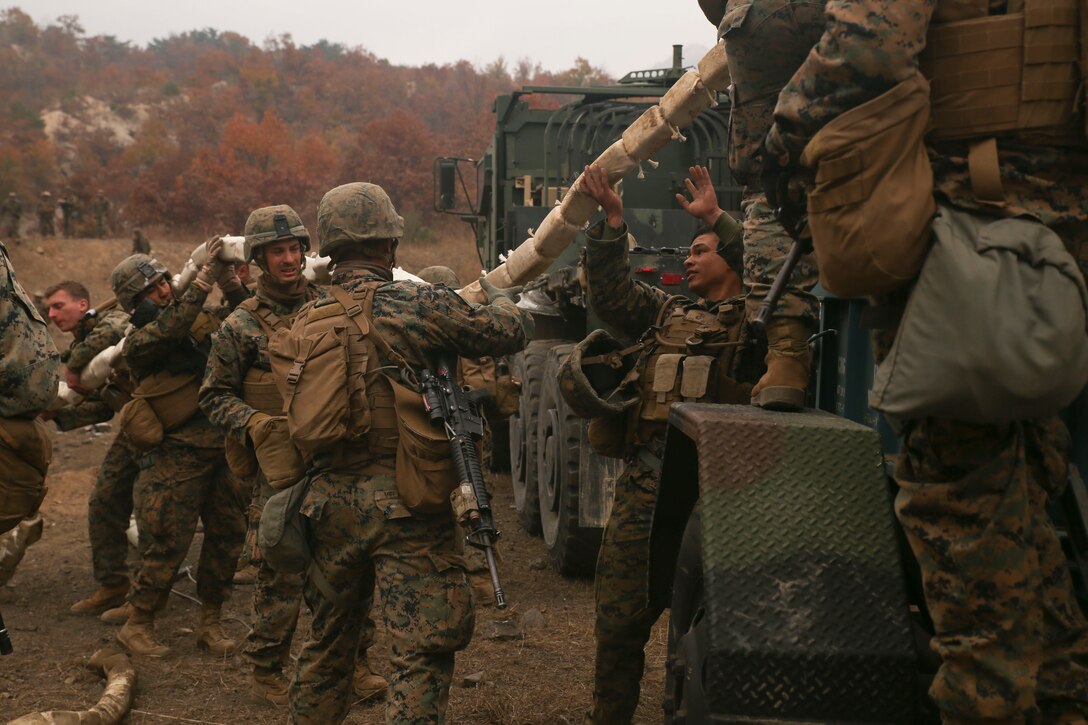 Combat engineers with Engineer Support Company, Combat Logistics Battalion 3, Combat Logistics Regiment 3, load an inert mine-clearing charge onto a trailer, Nov. 1, 2017 at Rodriguez Live Fire Range, Paju, South Korea. The Marines with CLB-3 practiced firing inert and live mine-clearing charges as a part of Exercise Winter Workhorse 17/ Korean Marine Exchange Program 18.1, which familiarizes the American armed forces with the Korean Peninsula and builds upon an enduring alliance between the two militaries. (U.S. Marine Corps photo by Sgt. Tiffany Edwards)