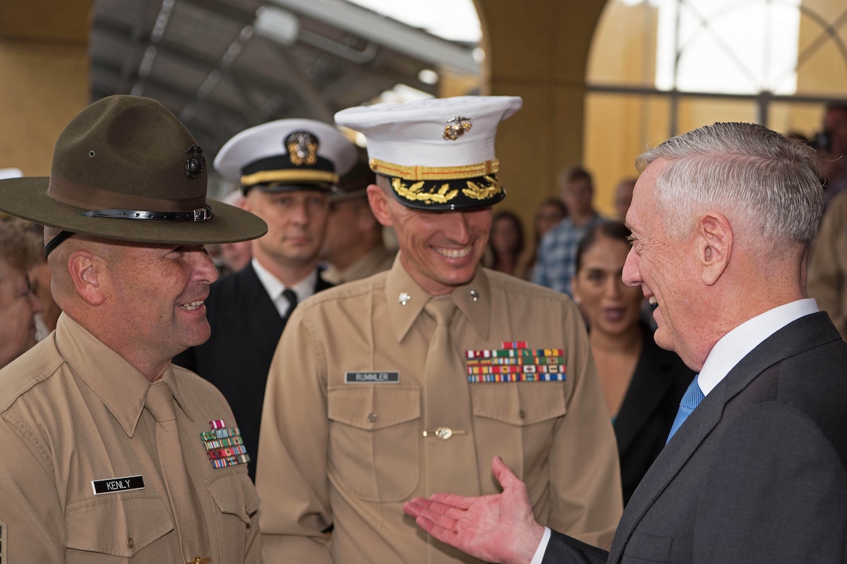 Defense Secretary Jim Mattis talks with a group of people.