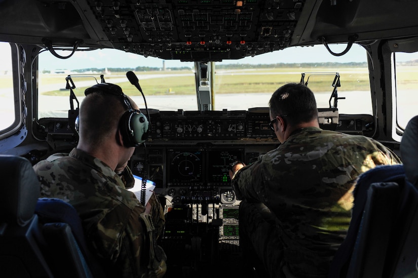 Maj. Benjamin Buxton, right, and 1st Lt. Casey Larson, left, 16th Airlift Squadron, 437th Airlift Wing pilots, perform preflight checks before a mission to support search and rescue operations in Argentina, Nov. 18, 2017. Joint Base Charleston's efforts are helping aid the search and rescue of the A.R.A. San Juan, an Argentine navy submarine that went missing Nov. 15, 2017. As part of the support, two C-17 Globemaster IIIs and one C-5M Super Galaxy from Air Mobility Command are delivering needed equipment and expertise to assist a partner nation. The first flight from Joint Base Charleston is carrying a tow bar, a Tunner 60K Aircraft Cargo Loader and three members of the 437th Aerial Port Squadron. While on the ground, the team will be conducting runway assessments prior to other equipment arriving in country. Additional U.S. Air Force support will be provided to aid efforts.