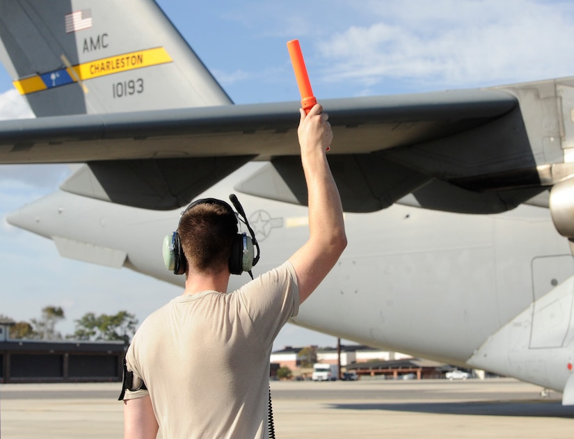 Staff Sgt. Jacob Enfinger, 437th Aircraft Maintenance Squadron crew chief, marshals a C-17 Globemaster III aircraft at Joint Base Charleston for a mission headed to Argentina, Nov. 18, 2017. Joint Base Charleston's efforts are helping aid the search and rescue of the A.R.A. San Juan, an Argentine navy submarine that went missing Nov. 15, 2017. As part of the support, two C-17 Globemaster IIIs and one C-5M Super Galaxy from Air Mobility Command are delivering needed equipment and expertise to assist a partner nation. The first flight from Joint Base Charleston is carrying a tow bar, a Tunner 60K Aircraft Cargo Loader and three members of the 437th Aerial Port Squadron. While on the ground, the team will be conducting runway assessments prior to other equipment arriving in country. Additional U.S. Air Force support will be provided to aid efforts.