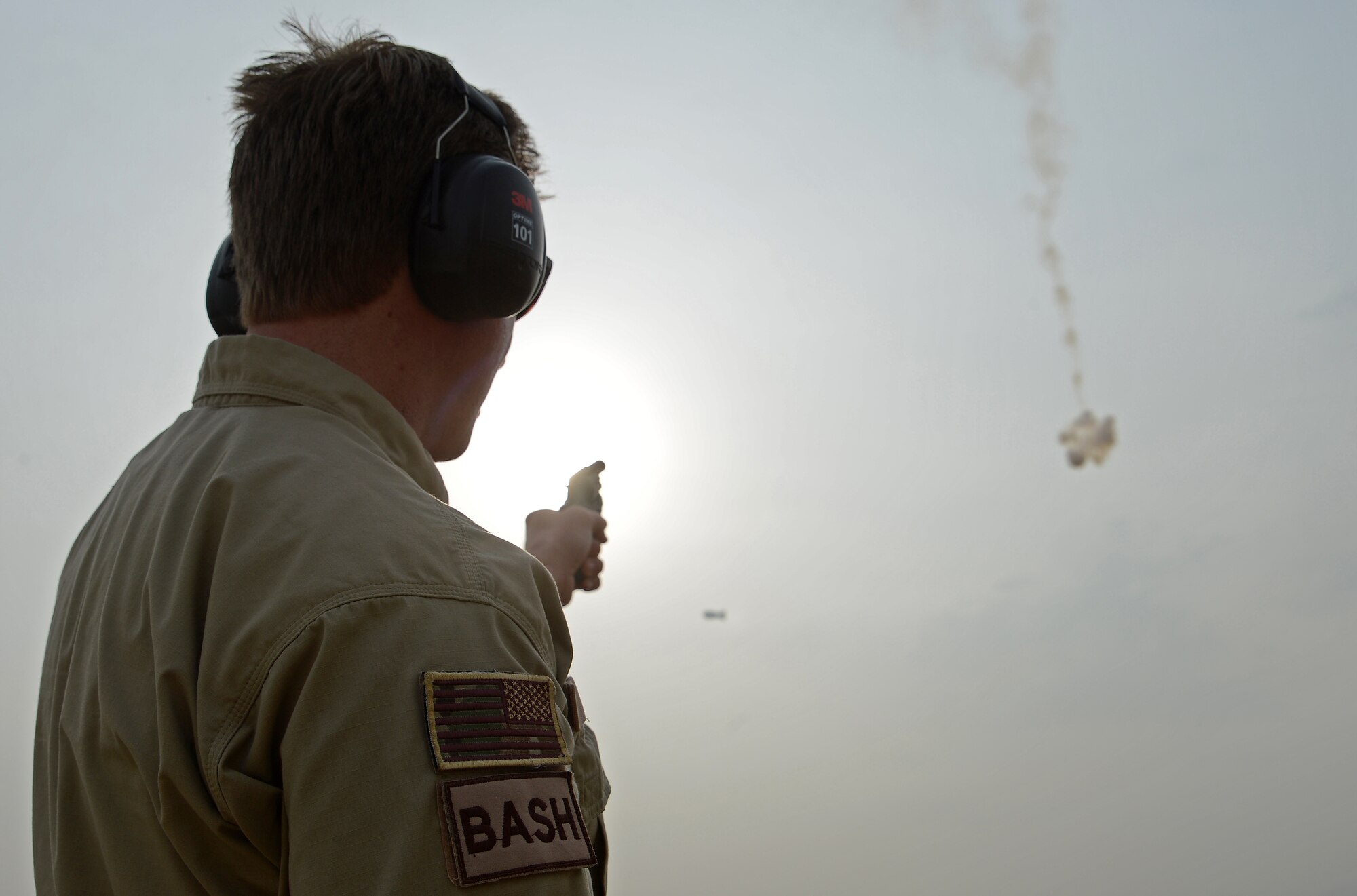 James Capps, 455th Air Expeditionary Wing U.S. Department of Agriculture (APHIS) and BASH forward operating base biologist, shoots off a pyrotechnic to harass a flock of Eurasian tree sparrows, Nov. 21, 2017 at Bagram Airfield, Afghanistan.
