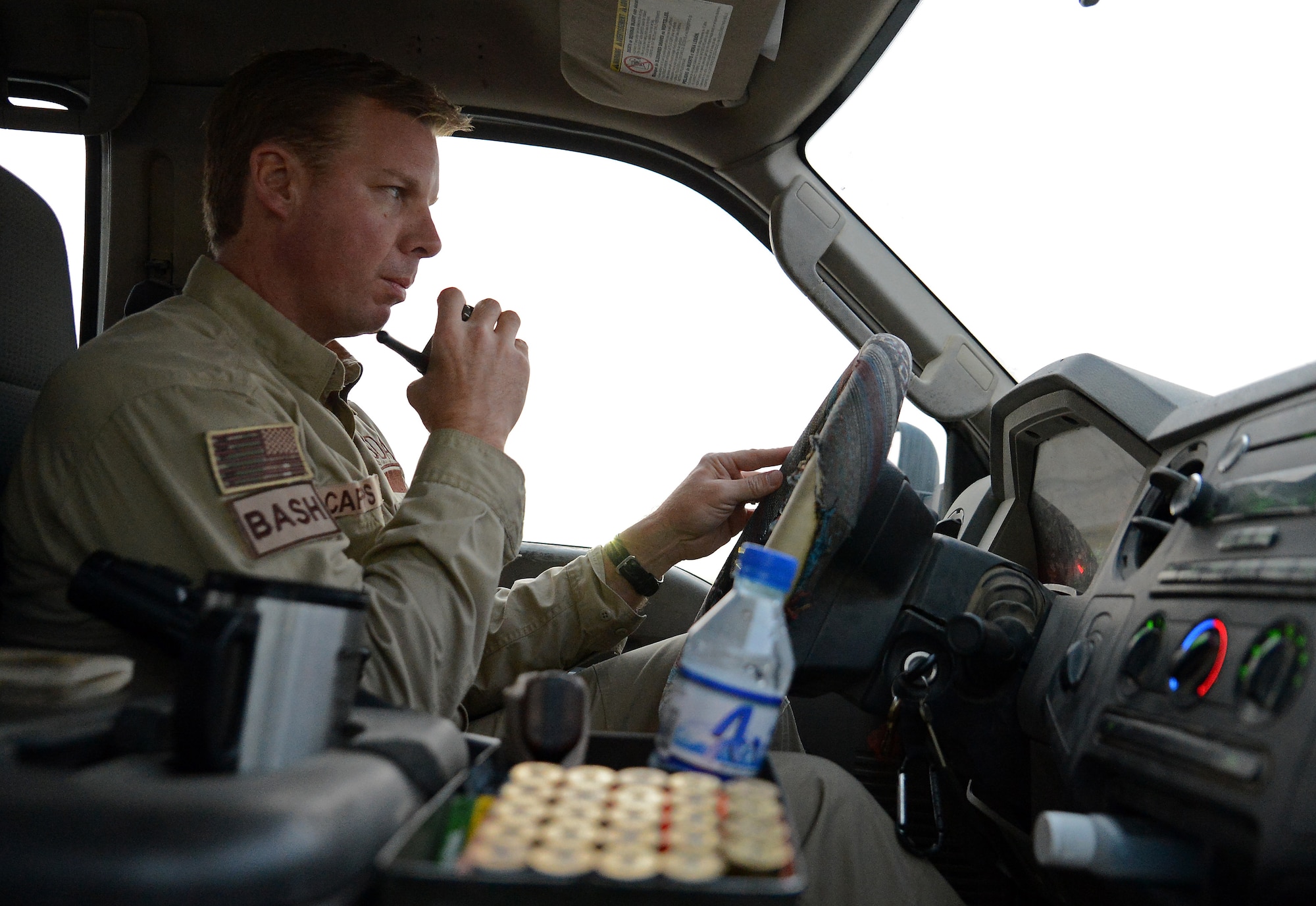 James Capps, 455th Air Expeditionary Wing U.S. Department of Agriculture (APHIS) and BASH forward operating base biologist, radios in to the air traffic control tower before crossing the runway Nov. 21, 2017 at Bagram Airfield, Afghanistan.
