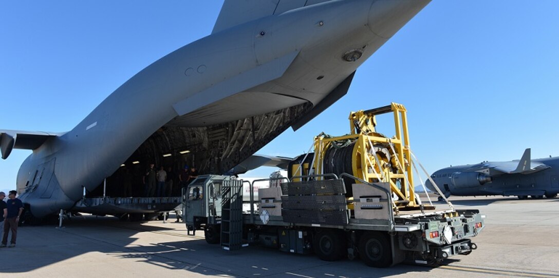 Cargo is loaded onto a military airplane.