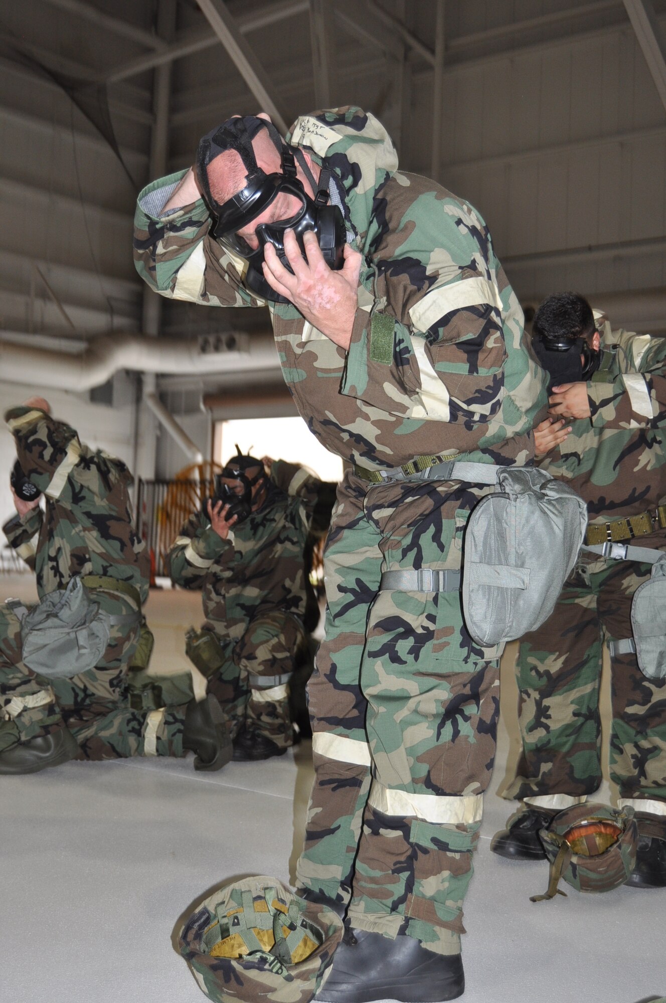 Tech Sgt. Ben Reid, 433rd Aircraft Maintenance Squadron crew chief, dons his gas mask during an Ability to Survive and Operate training exercise along the flight line on Joint Base San Antonio-Lackland, Texas on Nov. 18, 2017. The focus of the training was geared toward responding to chemical, biological, radiological and nuclear threats in a deployed environment.  (U.S. Air Force photo/Senior Airman Bryan Swink)