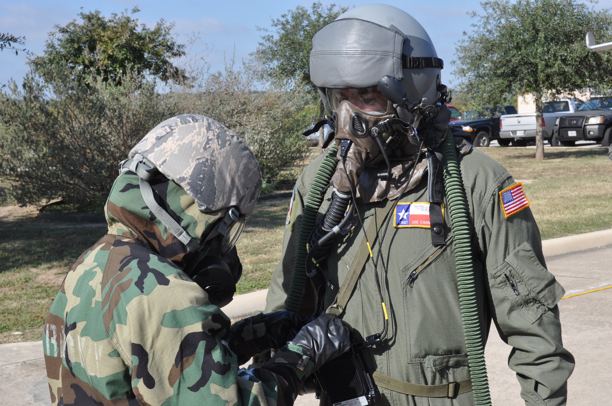 Tech. Sgt. Joseph Cannella, 68th Airlift Squadron loadmaster, goes through the decontamination process after a simulated chemical, biological, radiological and nuclear attack during an Ability to Survive and Operate training exercise on Joint Base San Antonio-Lackland, Texas on Nov. 18, 2017. ATSO training is designed to provide Airmen opportunities to respond and react to external threats in a simulated deployed environment. (U.S. Air Force photo/Senior Airman Bryan Swink)