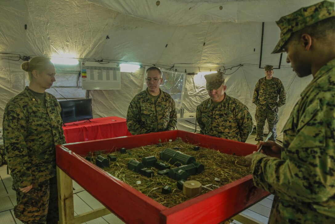 Evaluators with II Marine Expeditionary Force observe a terrain model detailing the layout of the area of operations during the Maj. Gen. William Pendleton Thompson Hill Awards for food service excellence competition at Camp Lejeune, N.C., Nov. 15, 2017. The W.P.T. Hill award recognizes the best expeditionary dining facility in the Marine Corps for outstanding performance. Evaluator’s judged the unit based on their standards regarding operations, sanitation, taste and quality of the food served.