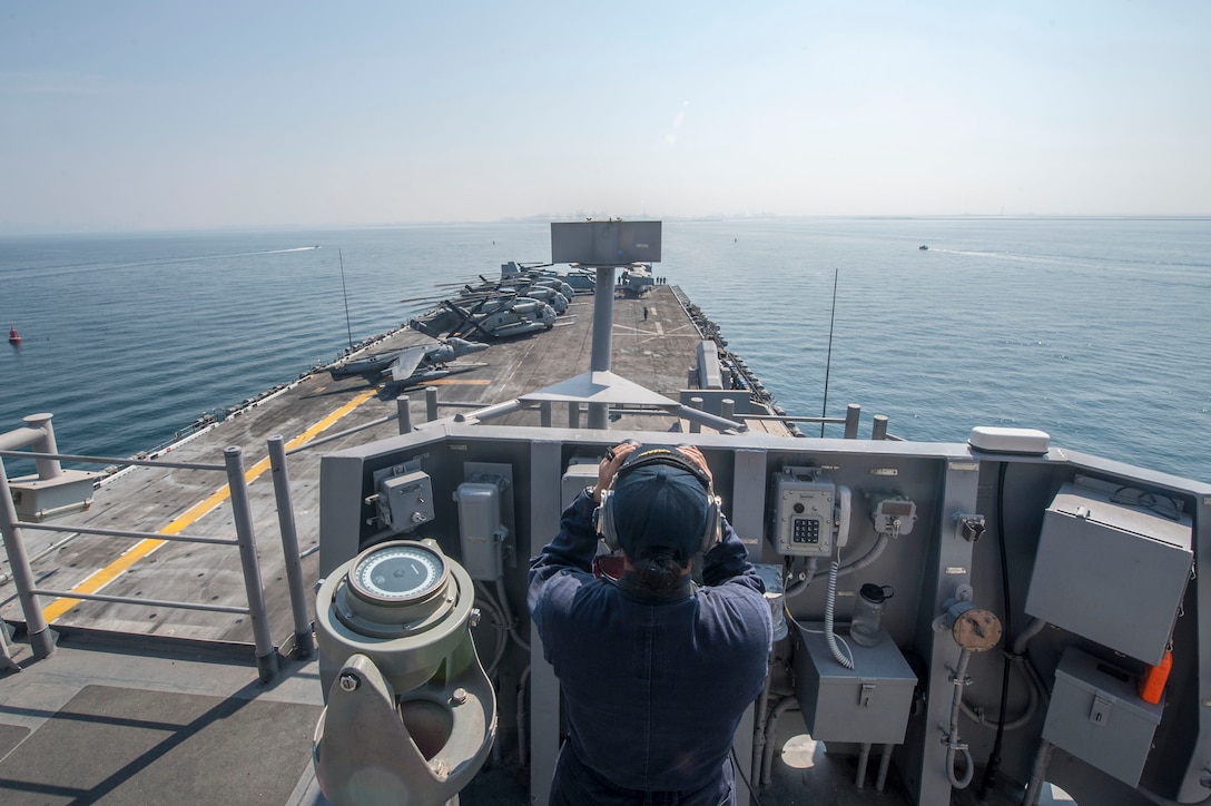 171110-N-ZS023-023 ARABIAN GULF (Nov. 10, 2017) Seaman Lea Sabino, a native of Chula Vista, Calif., assigned to  deck department aboard the amphibious assault ship USS America (LHA 6), stands the forward look out watch as the ship prepares to enter Jebel Ali, United Arab Emirates for a port visit. America is deployed to the U.S. 5th Fleet area of operations in support of maritime security operations designed to reassure allies and partners, and preserve the freedom of navigation and the free flow of commerce in the region. (U.S. Navy photo by Mass Communication Specialist Seaman Vance Hand/Released)