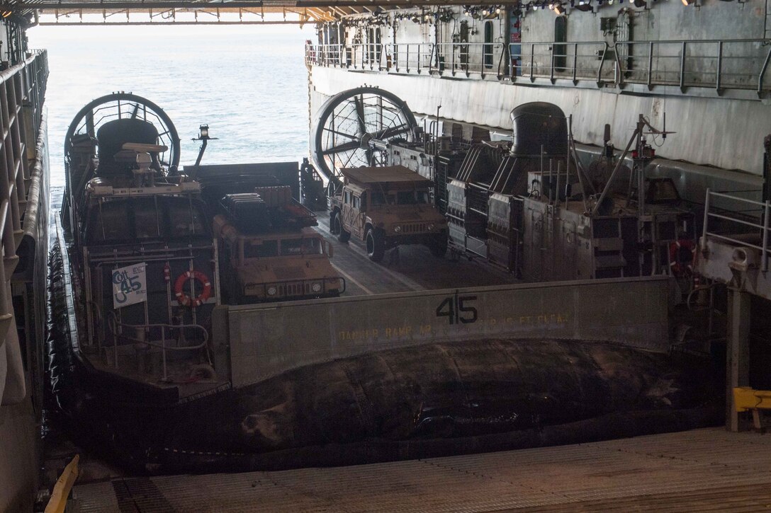 171109-N-OW019-114 U.S 5TH FLEET AREA OF OPERATIONS (Nov. 09, 2017) A landing craft, air cushion, operated by Sailors assigned to Assault Craft Unit 5, prepares to depart the well deck of the amphibious dock landing ship USS Pearl Harbor (LSD 52). Pearl Harbor is deployed in the U.S. 5th Fleet area of operations in support of maritime security operations designed to reassure allies and partners, and preserve the freedom of navigations and the free flow of commerce in the region. (U.S. Navy photo by Mass Communication Specialist 3rd Class Logan C. Kellums/Released)