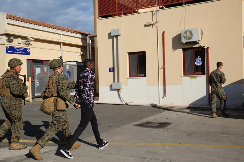U.S. Marines assigned to Special Purpose Marine Air-Ground Task Force-Crisis Response-Africa detain a suspect during non-combatant evacuation operation training aboard Naval Air Station Sigonella, Italy, on Nov. 17, 2017. SPMAGTF-CR-AF deployed to conduct limited crisis-response and theater-security operation in Europe and Africa.