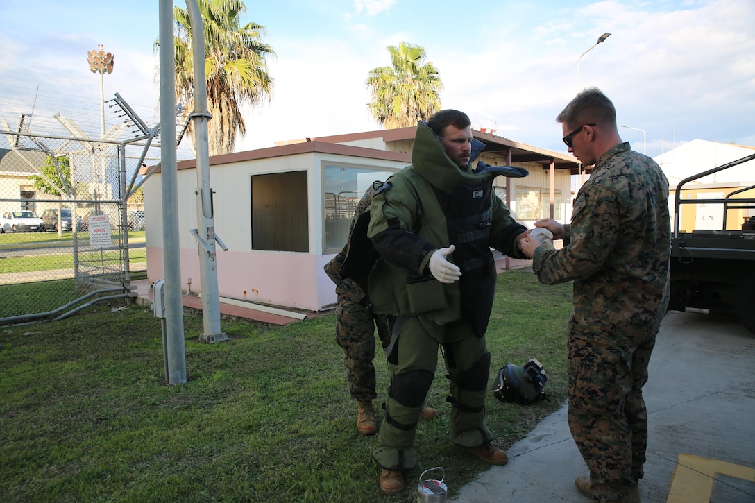 An Explosive Ordnance Disposal technician assigned to Special Purpose Marine Air-Ground Task Force-Crisis Response-Africa suits up during non-combatant evacuation operation training aboard Naval Air Station Sigonella, Italy, on Nov. 17, 2017. SPMAGTF-CR-AF deployed to conduct limited crisis-response and theater-security operation in Europe and Africa.
