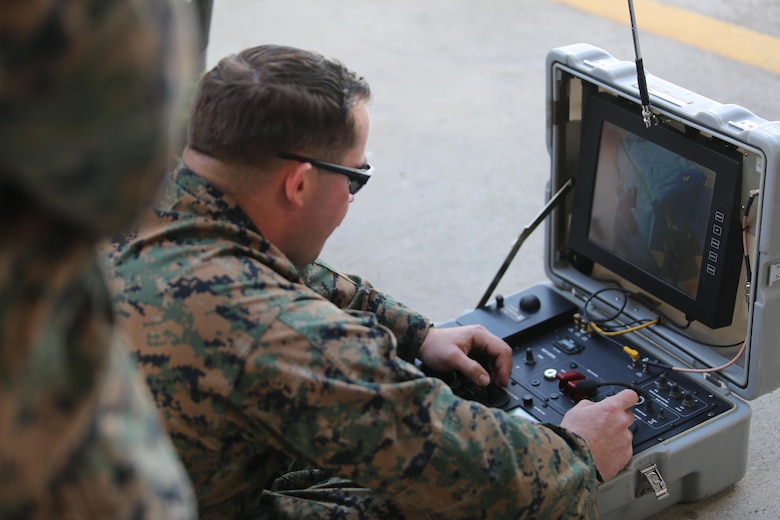 An Explosive Ordnance Disposal technician assigned to Special Purpose Marine Air-Ground Task Force-Crisis Response-Africa controls a bomb disposal robot during non-combatant evacuation operation training aboard Naval Air Station Sigonella, Italy, on Nov. 17, 2017. SPMAGTF-CR-AF deployed to conduct limited crisis-response and theater-security operation in Europe and Africa.