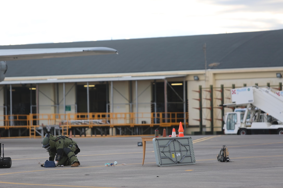 An Explosive Ordnance Disposal technician assigned to Special Purpose Marine Air-Ground Task Force-Crisis Response-Africa inspect suspicious luggage during non-combatant evacuation operation training aboard Naval Air Station Sigonella, Italy, on Nov. 17, 2017. SPMAGTF-CR-AF deployed to conduct limited crisis-response and theater-security operation in Europe and Africa.