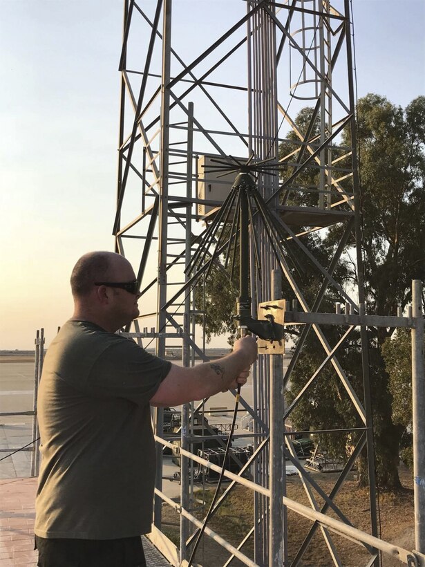 Air Force Tech. Sgt. Clayton Allen, 22nd Air Refueling Wing, installs a communications antenna at Moron Air Base, Spain, Oct. 10, 2017. Allen is a water and fuels systems maintenance technician who’s self-taught in computer programming and satellite and ground command-and-control radio systems. Air Force photo by Senior Airman Jenna Caldwell