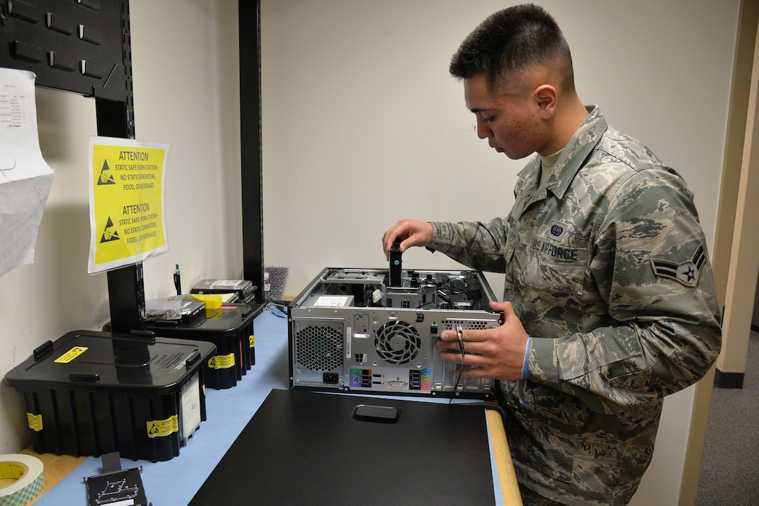 Airman 1st Class Haden-Paul Cruz, 341st Communications Squadron client support technician, replaces a hard drive Nov. 15, 2017, at Malmstrom Air Force Base, Mont.
