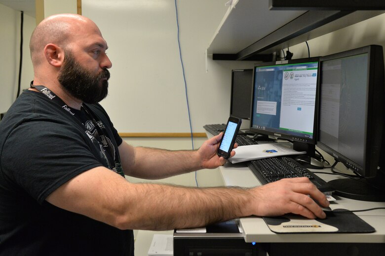 Bill McKowan, 341st Communications Squadron client systems technician, works on a phone Nov. 15, 2017, at Malmstrom Air Force Base, Mont.