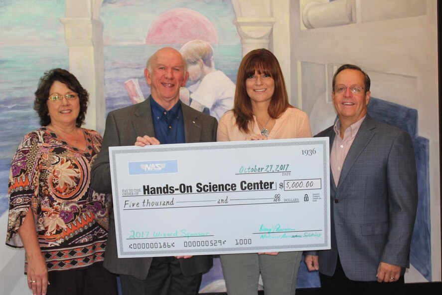 : Doug Pearson, deputy general manager of National Aerospace Solutions, LLC, the contractor overseeing the AEDC Test Operations and Sustainment contract, presents a check for $5,000 to Deb Wimberley, director of the Hands on Science Center in Tullahoma, to help support the HOSC’s Science, Technology, Engineering and Math (STEM) programs. AEDC supports many STEM efforts throughout middle Tennessee impacting nearly 19,000 students in more than 60 schools since 2013. AEDC also has a program dedicated to STEM at Arnold Air Force Base. Pictured left to right are Carole Thomas, president of the HOSC Board of Directors; Pearson; Wimberly; and Jim Jolliffe, a member of the HOSC Board of Directors. (Courtesy photo)