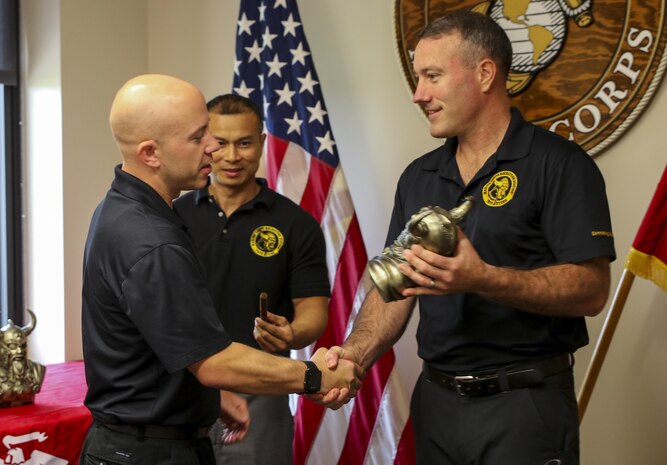 Maj. Andrew Nicholson, the Recruiting Staion Twin Cities commanding officer, awards GySgt. Timothy Bunde the RS Twin Cities staff noncommissioned officer of the year award. Bunde is a native of the St. Cloud, Minnesota area and hopes to continue to be successful as a station commander and eventually return to the operating forces as a first sergeant.  (Official U.S. Marine Corps photo by Sgt. Michelle Reif)