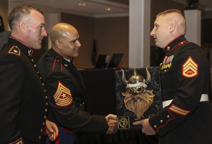 Maj. Andrew Nicholson, the Recruiting Station Twin Cities commanding officer, awards Staff Sgt. John Bateman the RS Twin Cities recruiter of the year award. Bateman, who is in his second year of recruiting, says he owes his success to hard work and dedication to the Marine Corps. (Official U.S. Marine Corps photo by Sgt. Michelle Reif)