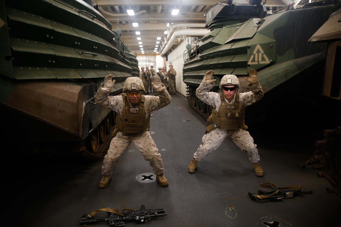 Two Marines perform a workout.