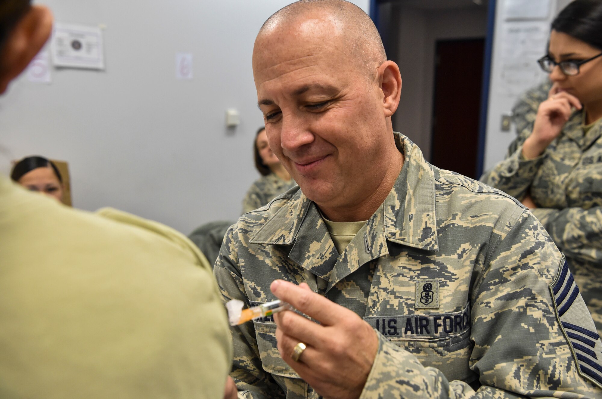 Chief Master Sgt. Joseph Powell, 628th Medical Group command chief, administers flu vaccines to base members during a during a mass-immunization exercise at Joint Base Charleston, S.C., Nov. 15, 2017.