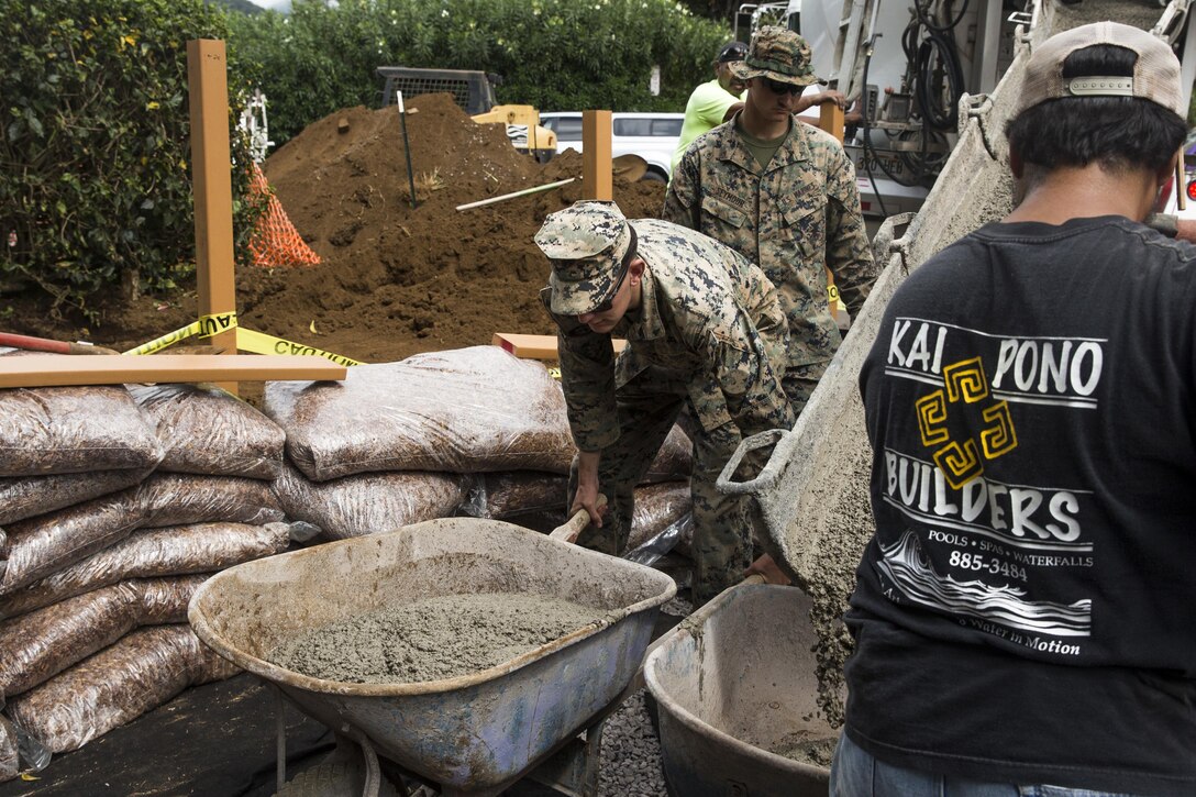 Lance Cpl. John Lewis moves a wheelbarrow full of cement during a construction project at Kamuela, on the island of Hawaii, Oct. 28, 2017. Lewis is an engineer equipment mechanic with Combat Logistics Battalion 3, and a native of Houston. U.S. Marines with CLB-3 are helping rebuild a local community playground alongside volunteers from Kamuela. (U.S. Marine Corps photo by Lance Cpl. Isabelo Tabanguil)