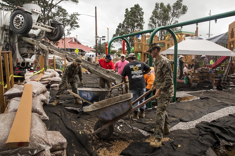 U.S. Marines dump and refill wheelbarrows full of cement during a construction project. The Marines are with Combat Logistics Battalion 3, and are helping rebuild a community playground at Kamuela, on the island of Hawaii, Oct. 28, 2017. (U.S. Marine Corps photo by Lance Cpl. Isabelo Tabanguil)