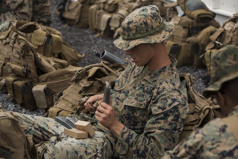 Lance Cpl. Andrew Daniels loads bullets into magazines before participating in the Infantry Platoon Battle Course for Exercise Bougainville II at the Pohakuloa Training Area on the Island of Hawaii, Oct. 25, 2017. Daniels is a rifleman with 2nd Battalion, 3rd Marine Regiment, and a native of Jacksonville, Fla.  Exercise Bougainville II prepares 2nd Bn., 3rd Marines for service as a forward deployed force in the Pacific by training them to fight as a ground combat element in a Marine Air-Ground Task Force. (U.S. Marine Corps photo by Lance Cpl. Isabelo Tabanguil)