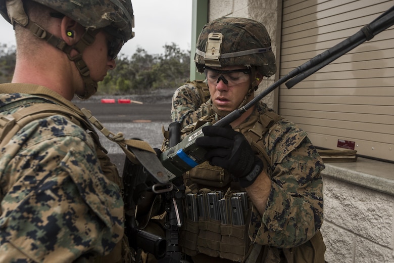 Cpl. Trevor Cooper checks a radio before participating in the Infantry Platoon Battle Course for Exercise Bougainville II at the Pohakuloa Training Area on the Island of Hawaii, Oct. 25, 2017. Cooper is a rifleman with 2nd Battalion, 3rd Marine Regiment, and is a native of Tucson, Ariz. Exercise Bougainville II prepares 2nd Bn., 3rd Marines for service as a forward deployed force in the Pacific by training them to fight as a ground combat element in a Marine Air-Ground Task Force. (U.S. Marine Corps photo by Lance Cpl. Isabelo Tabanguil)