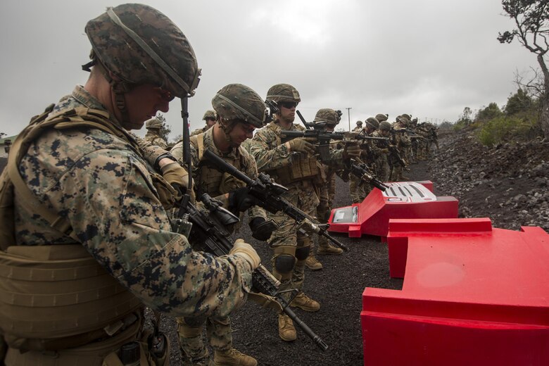 U.S. Marines load magazines into their rifles before participating in the Infantry Platoon Battle Course at the Pohakuloa Training Area on the Island of Hawaii, Oct. 25, 2017. The Marines are with 2nd Battalion, 3rd Marine Regiment, and are conducting IPBC for Exercise Bougainville II. Exercise Bougainville II prepares 2nd Bn., 3rd Marines for service as a forward deployed force in the Pacific by training them to fight as a ground combat element in a Marine Air-Ground Task Force. (U.S. Marine Corps photo by Lance Cpl. Isabelo Tabanguil)