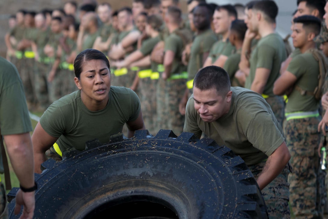 Marines assigned to the 1st Maintenance Battalion, 1st Marine Logistics Group, work together flipping tires during the 2017 Commanding General’s Cup competition on Camp Pendleton, Calif.