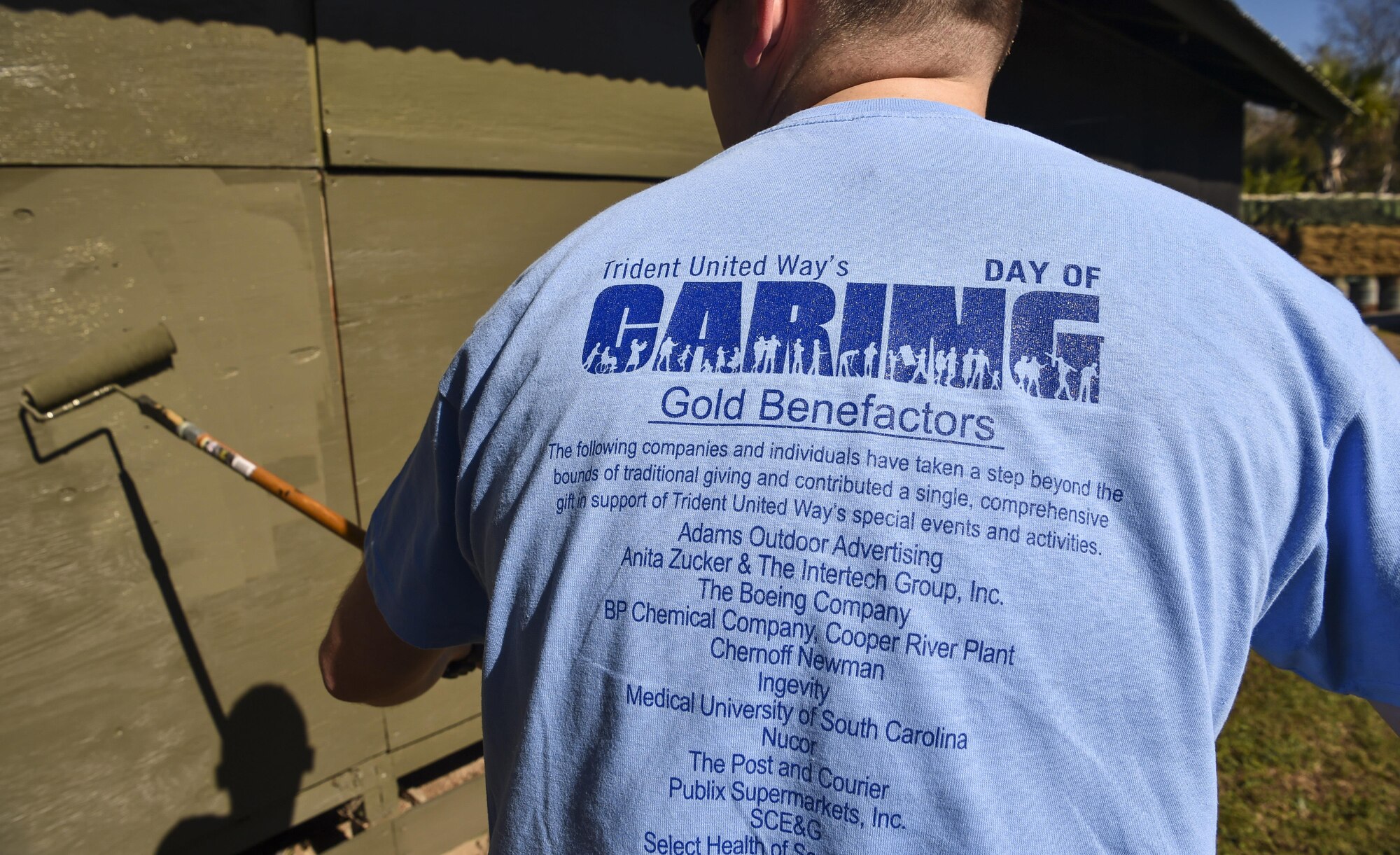 Machinist Mate Bryan Davis, Naval Nuclear Power Training Command fireman, paints a Vietnam memorial exhibit during Day of Caring at Patriot’s Point, Mount Pleasant, S.C., Nov. 17, 2017.