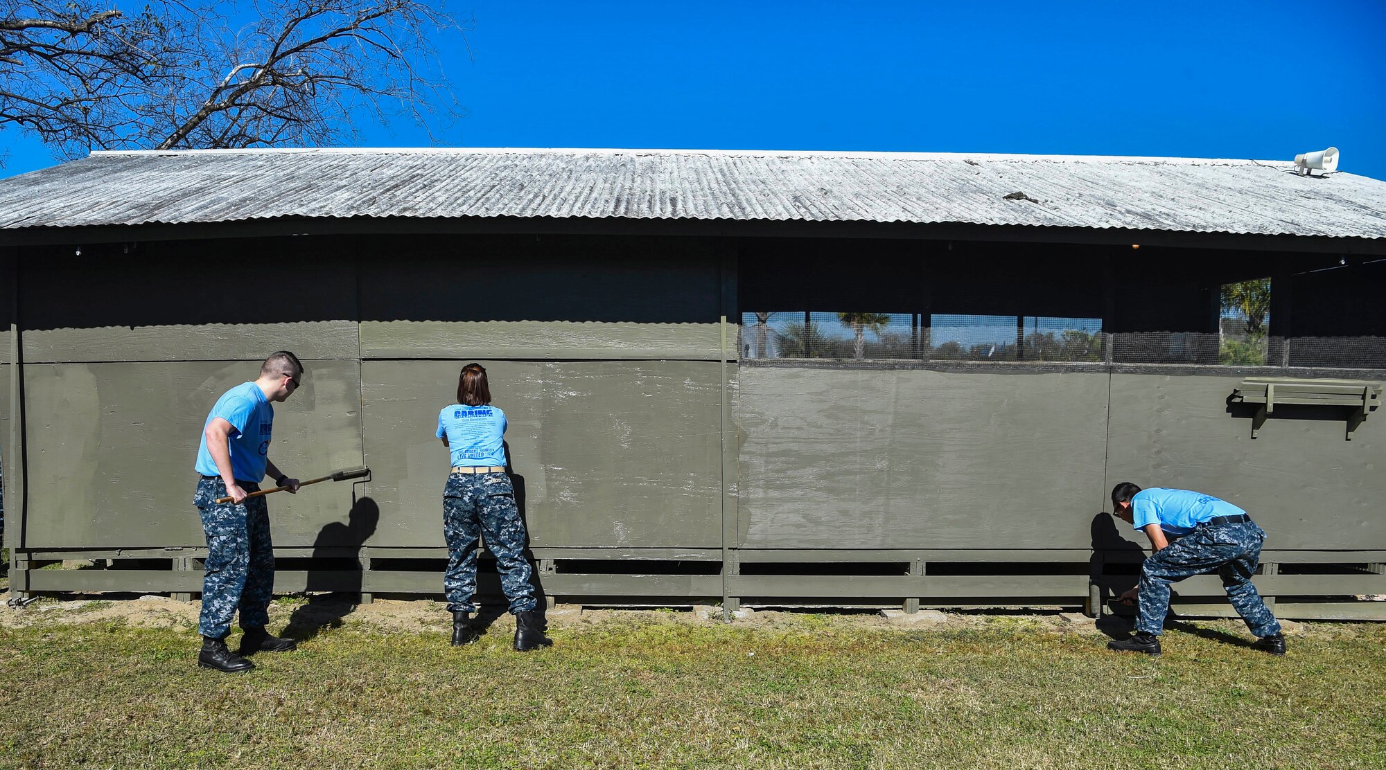 Joint Base Charleston members paint a Vietnam Memorial exhibit during the Day of Caring volunteer event at Patriot’s Point, Mount Pleasant, S.C., Nov. 17, 2017.