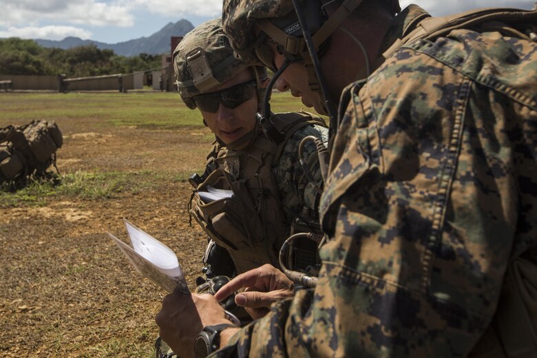 Gunnery Sgt. Dustin Vance (left) speaks with Capt. Josh Horman during a Tactical Recovery of Aircraft and Personnel training event in Exercise Bougainville II at Landing Zone Boondocker, Marine Corps Base Hawaii, on Oct. 26, 2017. Gunnery Sgt. Vance is a platoon sergeant, and a native of Mt. Sterling, Ky. Capt. Horman is a forward air controller, and is a native of Kansas City, Mo. Both Marines are with 2nd Battalion, 3rd Marine Regiment.  Exercise Bougainville II prepares 2nd Bn., 3rd Marines for service as a forward deployed force in the Pacific by training them to fight as a ground combat element in a Marine Air-Ground Task Force.   (U.S. Marine Corps photo by Lance Cpl. Isabelo Tabanguil)