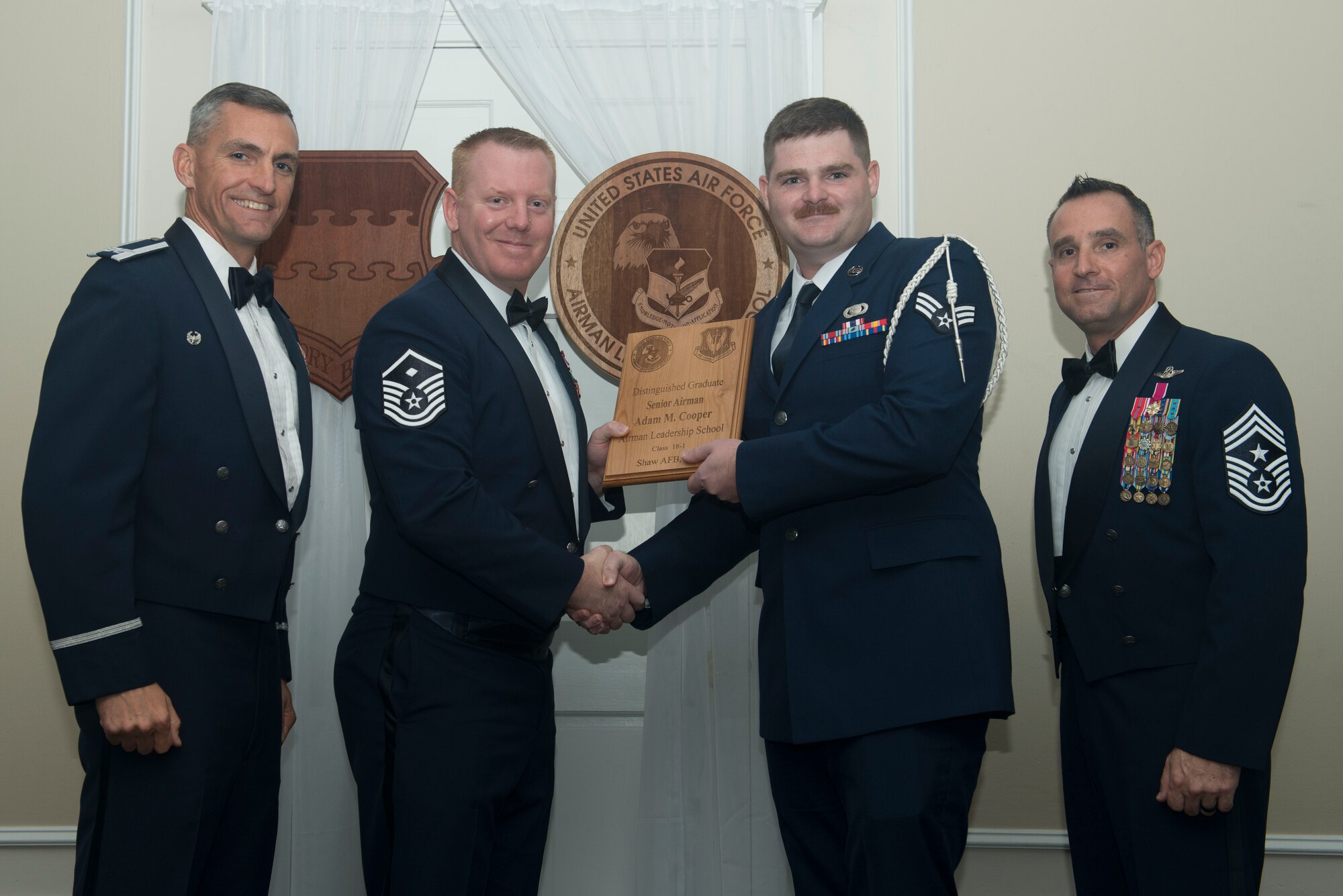 U.S. Air Force Senior Airman Adam Cooper, 3rd Intelligence Squadron, receives a distinguished graduate award for Class 18-1 of the Senior Master Sgt. David B. Reid Airman Leadership School, at Shaw Air Force Base, South Carolina, Nov. 17, 2017.