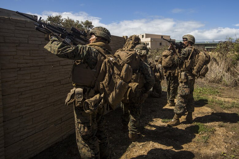 U.S. Marines move through a Military Operations in Urban Terrain town during Tactical Recovery of Aircraft and Personnel training event. The Marines are with 2nd Battalion, 3rd Marine Regiment, and are conducting a TRAP training event in Exercise Bougainville II at Landing Zone Boondocker, Marine Corps Base Hawaii, on Oct. 26, 2017. Exercise Bougainville II prepares 2nd Bn., 3rd Marines for service as a forward deployed force in the Pacific by training them to fight as a ground combat element in a Marine Air-Ground Task Force. (U.S. Marine Corps photo by Lance Cpl. Isabelo Tabanguil)