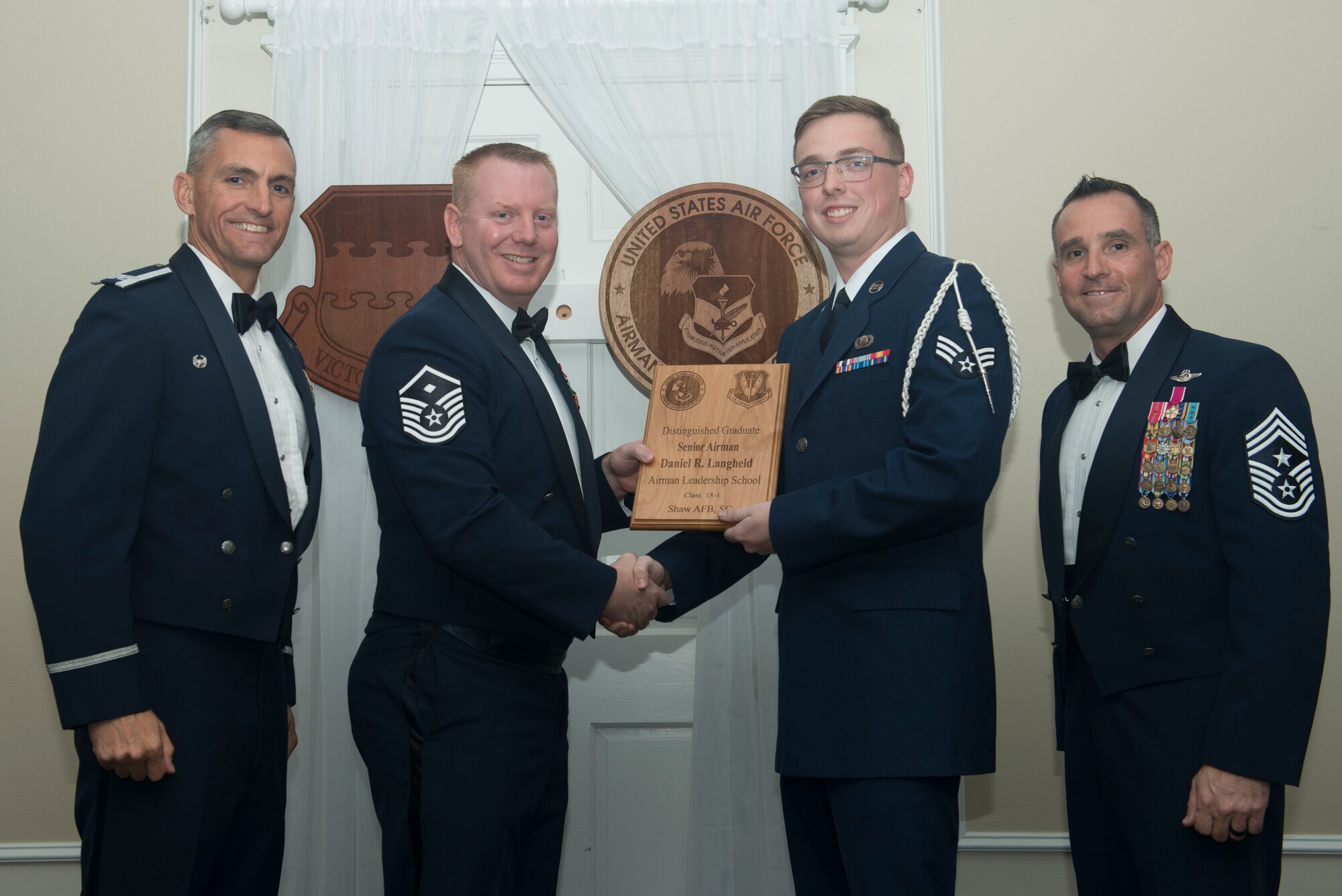 U.S. Air Force Senior Airman Daniel Langheld, 3rd Intelligence Squadron, receives a distinguished graduate award for Class 18-1 of the Senior Master Sgt. David B. Reid Airman Leadership School, at Shaw Air Force Base, South Carolina, Nov. 17, 2017.