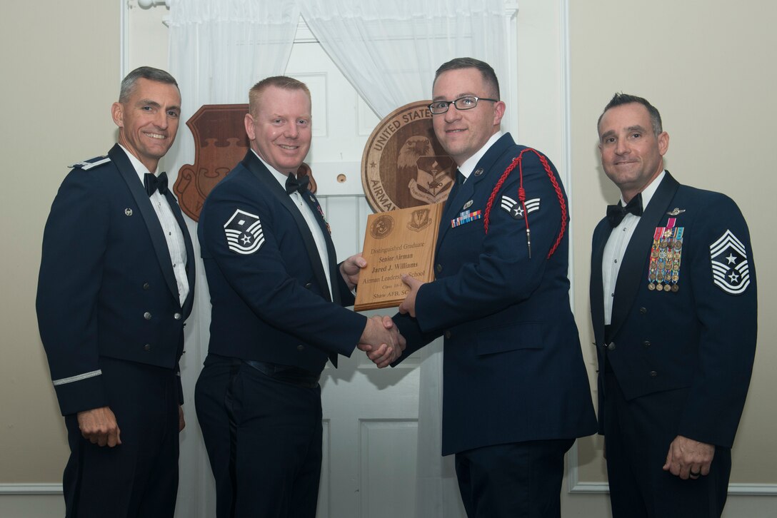 U.S. Air Force Senior Airman Jared Williams, 31st Intelligence Squadron, receives a distinguished graduate award for Class 18-1 of the Senior Master Sgt. David B. Reid Airman Leadership School, at Shaw Air Force Base, South Carolina, Nov. 17, 2017.