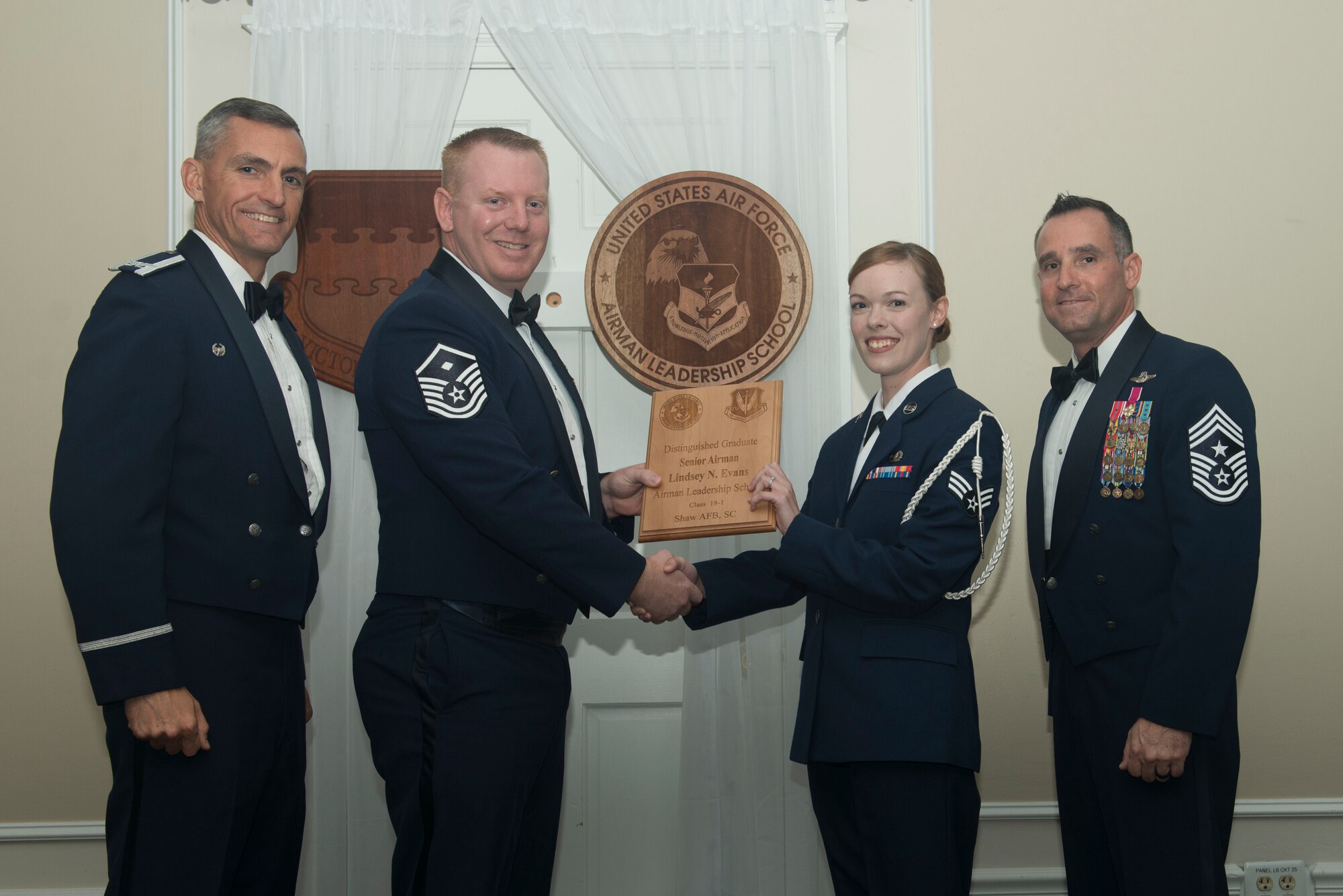 U.S. Air Force Senior Airman Lindsey Evans, 3rd Intelligence Squadron, receives a distinguished graduate award for Class 18-1 of the Senior Master Sgt. David B. Reid Airman Leadership School, at Shaw Air Force Base, South Carolina, Nov. 17, 2017.