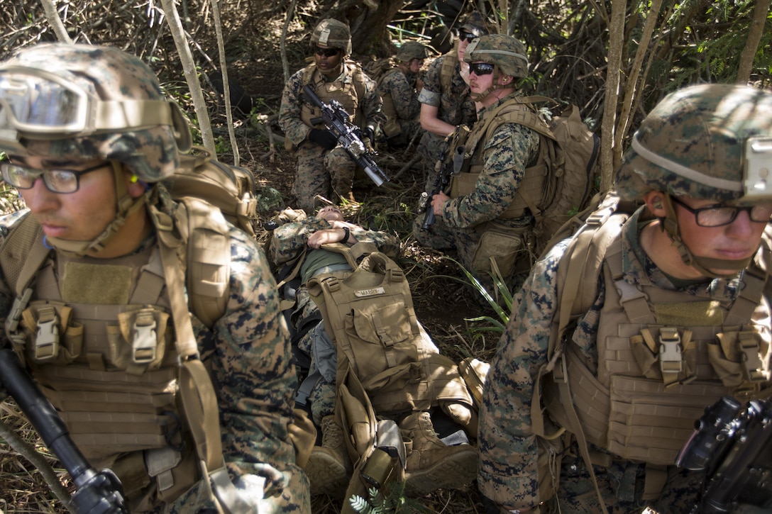 U.S. Marines prepare to move 2nd Lt. Mark Mabry role playing as a downed pilot during a Tactical Recovery of Aircraft and Personnel training event. 2nd Lt. Mabry is an infantry officer, and is a native of Benson, Ariz. The Marines are with 2nd Battalion, 3rd Marine Regiment, and are conducting a TRAP training event in Exercise Bougainville II at Landing Zone Boondocker, Marine Corps Base Hawaii, on Oct. 26, 2017. Exercise Bougainville II prepares 2nd Bn., 3rd Marines for service as a forward deployed force in the Pacific by training them to fight as a ground combat element in a Marine Air-Ground Task Force. (U.S. Marine Corps photo by Lance Cpl. Isabelo Tabanguil)