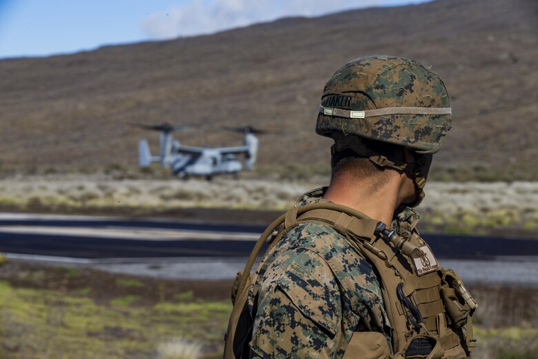 U.S. Marine Pfc. Colton Baker watches as an MV-22B Osprey lands at the Pohakuloa Training Area, on the island of Hawaii, Oct. 26, 2017. Marine Medium Tiltrotor Squadron 268 supported 2nd Battalion, 3rd Marine Regiment in a Tactical Recovery of Aircraft and Personnel training event during Exercise Bougainville II. Exercise Bougainville II prepares 2nd Bn., 3rd Marines for service as a forward deployed force in the Pacific by training them to fight as a ground combat element in a Marine Air-Ground Task Force. Pfc. Baker is a mortarman with 2nd Bn., 3rd Marines, and native of Miami, Fla. (U.S. Marine Corps photo by Sgt. Ricky Gomez)