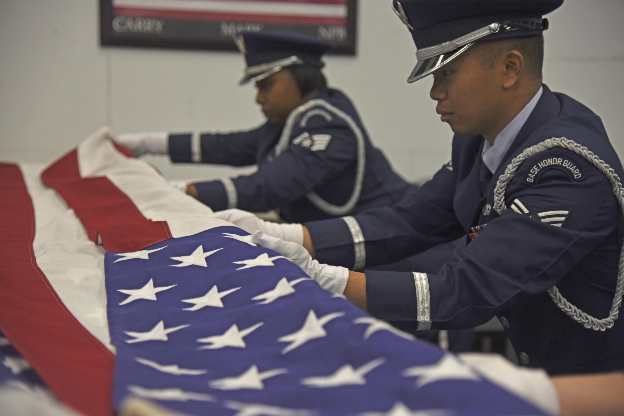 Senior Airman Arcell Salunga, 92nd Force Support Squadron Honor Guardsman, practices military funeral sequences with his flight Nov. 16, 2017, at Fairchild Air Force Base, Washington. Each new rotation begins with an intense 12-day training regimen. These two weeks focus on various color guard, funeral and rifle sequences and movements, starting with the basics and slowly introducing variations. (U.S. Air Force photo/Senior Airman Mackenzie Richardson)