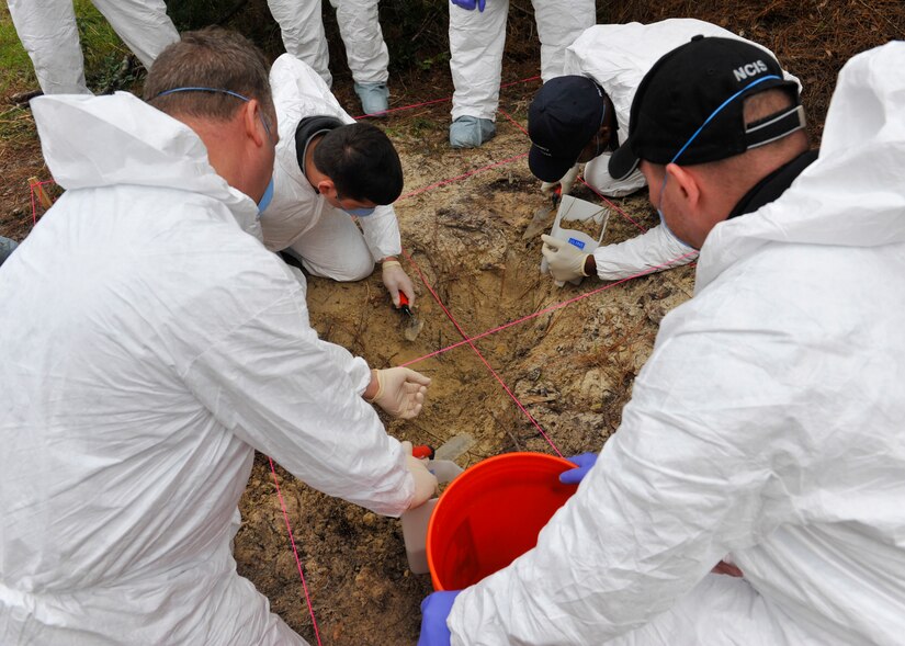 Participants examine a hidden ‘grave site’ during a clandestine grave and human remains recovery training at Joint Base Charleston, S.C., Nov. 14, 2017.