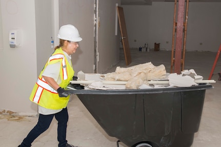 A member of the 502nd Civil Engineering Squadron cuts through a sheetrock wall during building renovations Nov. 18, 2017 at Joint Base San Antonio-Lackland. Forty office personnel from 502nd CES volunteered their weekend to help with renovations to meet a short deadline.