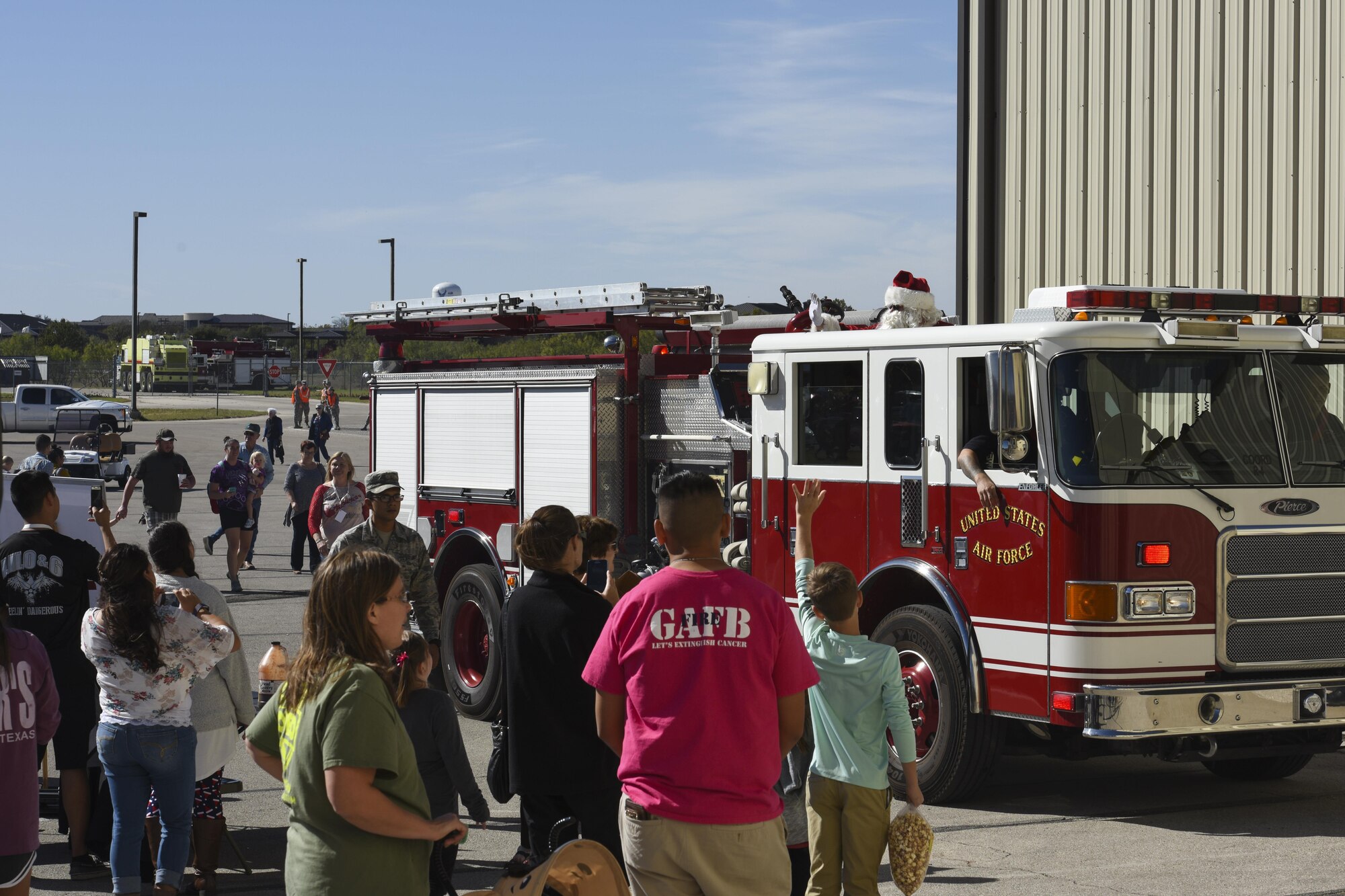 Santa Clause arrives to the Santa’s Market and Community Appreciation Day at the Louis F. Garland Department of Defense Fire Academy on Goodfellow Air Force Base, Texas, Nov. 18, 2017. Making his grand entrance to the event, Santa swapped his usual red sleigh for one of the Fire Academy’s firetrucks. (U.S Air Force photo by Airman 1st Class Zachary Chapman/Released)