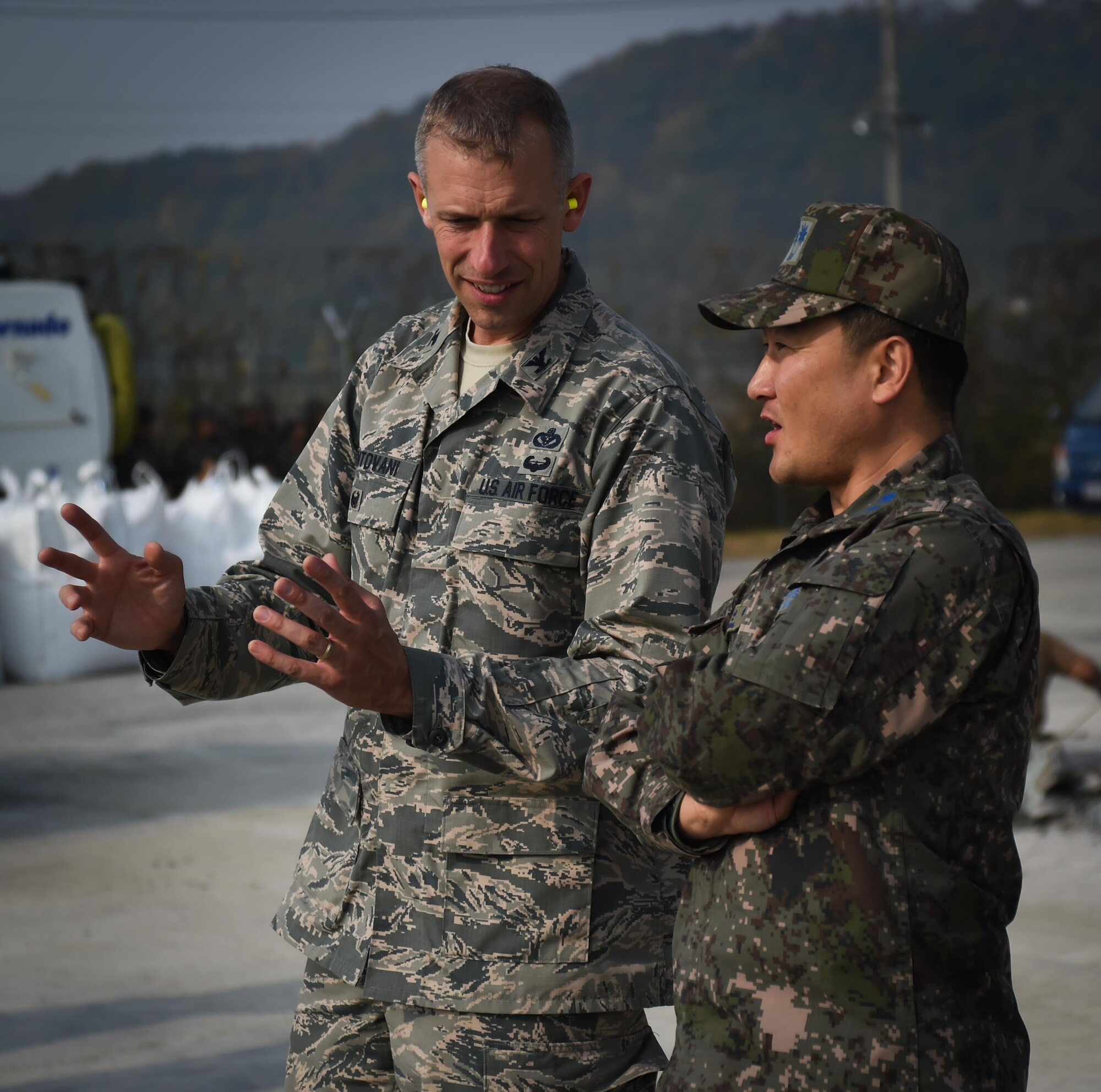U.S. Air Force Col. Kevin Mantovani, 7th Air Force engineering division chief, and Republic of Korea Air Force Lt. Col. Injae Hwang, Air Force Operation and Command, share ideas during a Rapid Airfield Damage Repair bilateral training exercise at Gwangju Air Base, R.O.K., Nov. 8, 2017. U.S. and R.O.K. Airmen trained together for a week to learn the new RADR process, preparing them for response to wartime contingencies, enhancing interoperability and building partnership capacity in the Indo-Asia Pacific region. (U.S. Air Force photo by Senior Airman Curt Beach)