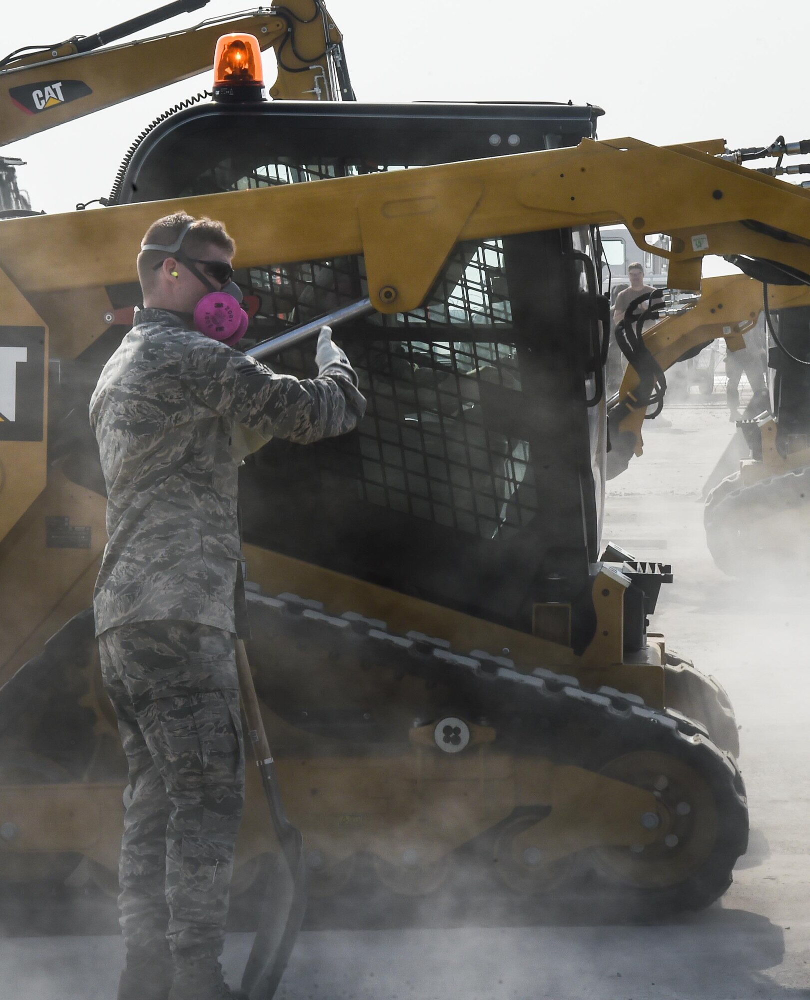 U.S. Air Force Senior Airman Tyler Rutledge, 773d Civil Engineer Squadron, directs a fellow Airman during a Rapid Airfield Damage Repair bilateral training exercise at Gwangju Air Base, Republic of Korea, Nov. 8, 2017. Approximately forty U.S. Airmen from the 773d CES at Joint Base Elmendorf-Richardson, Alaska, and 40 R.O.K. Airmen trained together for a week to learn a new runway repair process for wartime contingencies. The bilateral training exercise enhanced interoperability and built partnership capacity in the Indo-Asia Pacific region. (U.S. Air Force photo by Senior Airman Curt Beach)