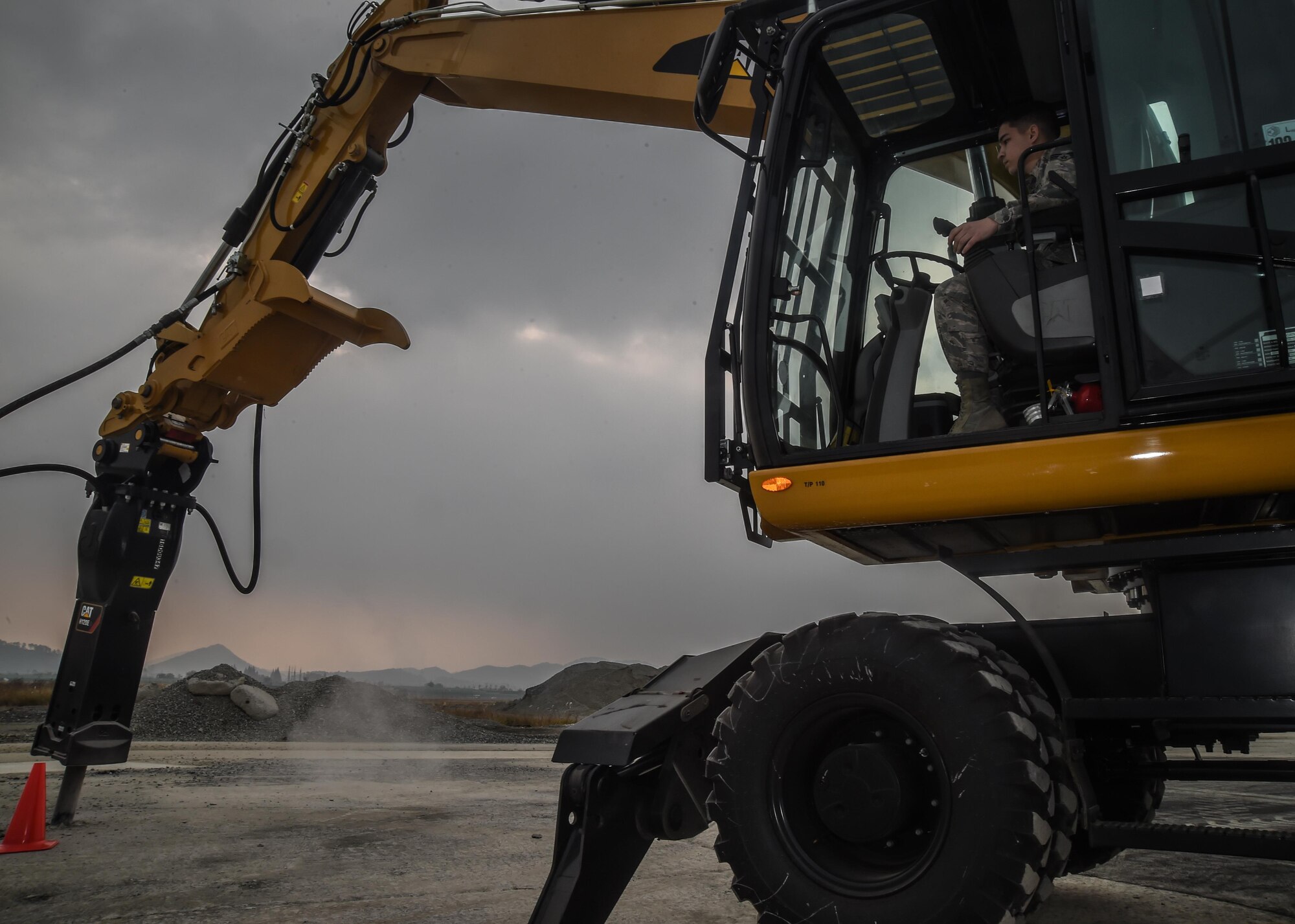U.S. Air Force Senior Airman Cameron Pinkerton, 773d Civil Engineer Squadron, excavates a crater during a Rapid Airfield Damage Repair training exercise at Gwangju Air Base, Republic of Korea., Nov. 8, 2017. Similar to an assembly line, RADR systematically lines up civil engineer personnel and equipment to quickly repair a runway after attack. The new process makes use of rapid-setting concrete which enables vehicles to pass over it after one hour, and any aircraft after two hours of cure time. (U.S. Air Force photo by Senior Airman Curt Beach)