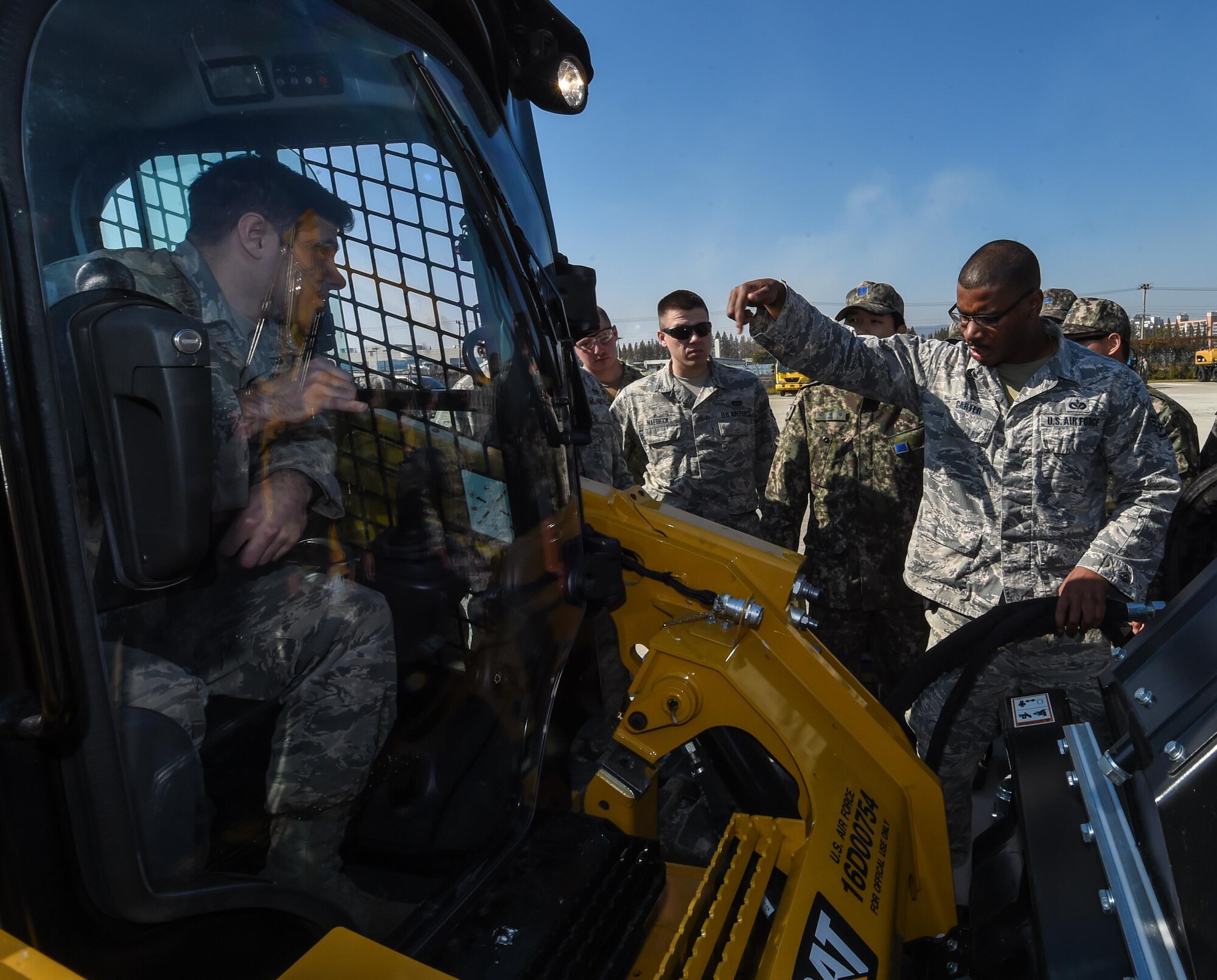 U.S. Air Force Staff Sgt. Marvin Carter, Air Force Civil Engineer Center contingency trainer, instructs U.S. and Republic of Korea Airmen during a bilateral training exercise at Gwangju Air Base, R.O.K., Nov. 6, 2017. Approximately forty U.S. Airmen from the 773d Civil Engineer Squadron at Joint Base Elmendorf-Richardson, Alaska, and 40 Republic of Korea Airmen from Gwangju trained together for a week to learn a new runway repair process for wartime contingencies. The bilateral training exercise enhanced interoperability and built partnership capacity in the Indo-Asia Pacific region. (U.S. Air Force photo by Senior Airman Curt Beach)